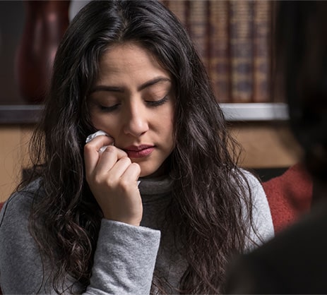 woman in pain at risk for opioid addiction